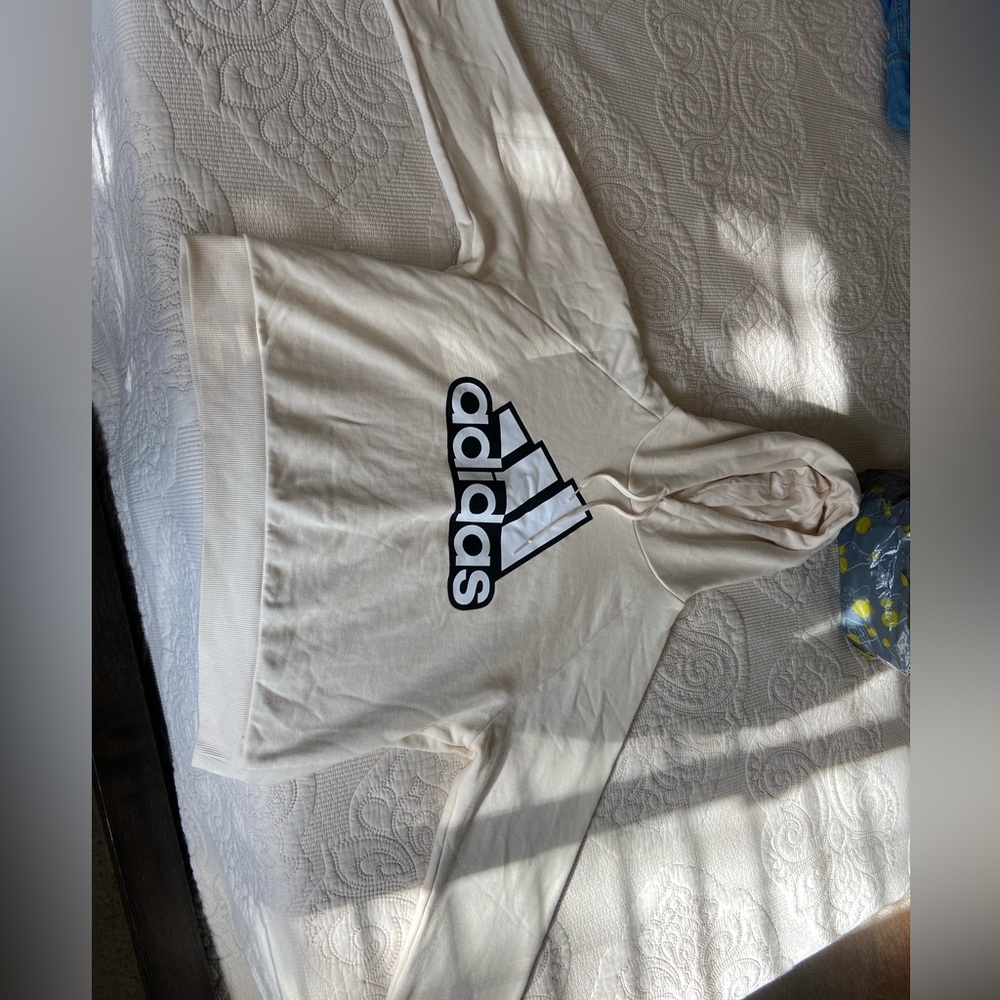 Cream colored Adidas hoodie.